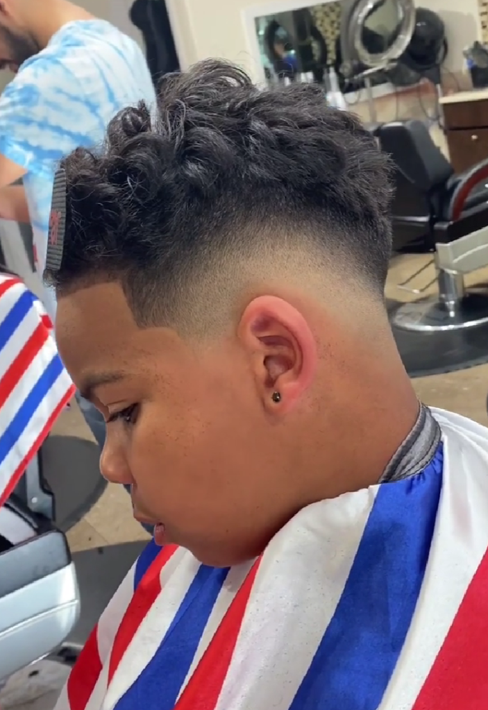 Mid-skin fade with curly top. Razor line up on hairline. (Brauunson's work).